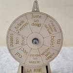 Roue de la mort en bois, avec 8 gages différents gravés. Installé de face sur une nappe en velour