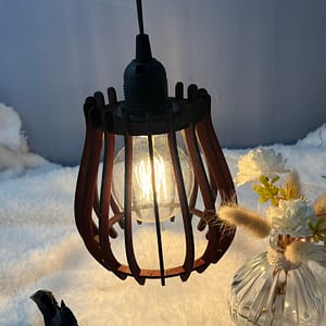 Baladeuse en bois Woom, avec son ampoule allumée. Disposée sur une nappe en velour et à côté d'un écureuil en 3D et d'un vase en verre